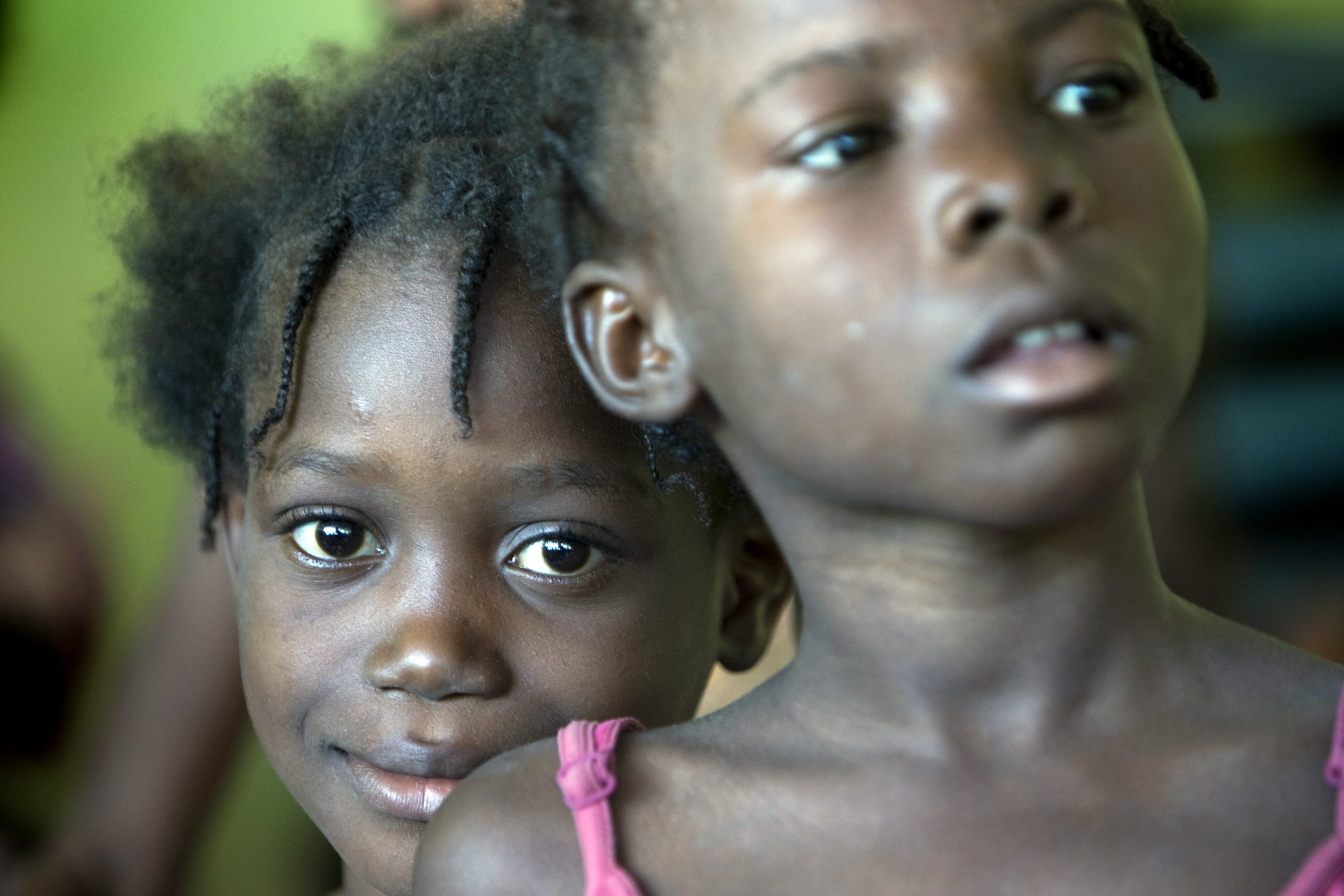 A kid poses for a photo during an animation performed by Brazilian UN peacekeepers